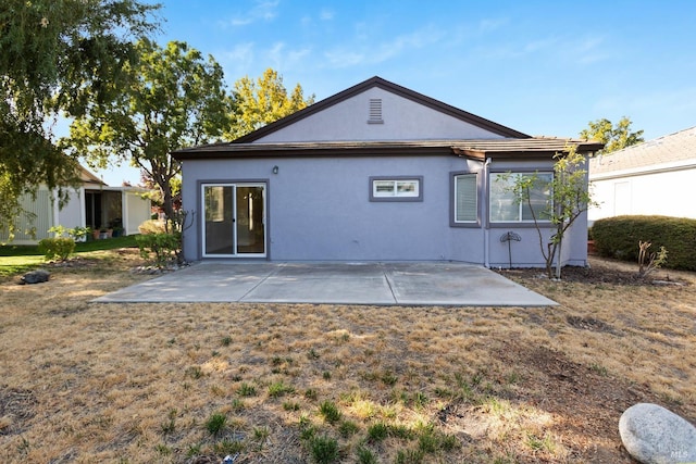 rear view of house with a patio