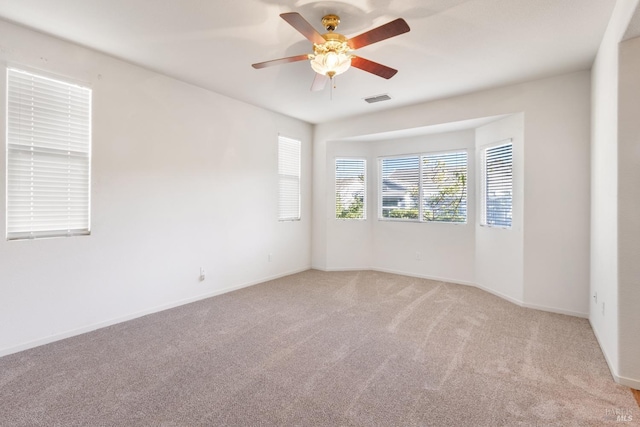 carpeted spare room with ceiling fan