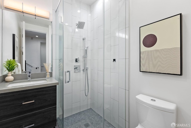 bathroom with walk in shower, vanity, and toilet