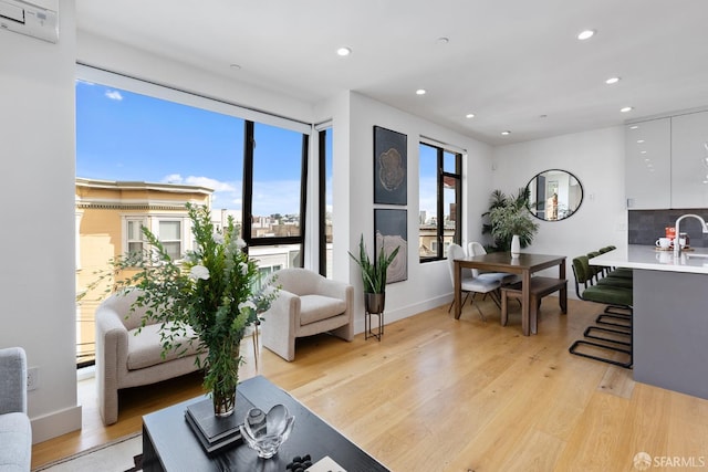 living room with sink and light hardwood / wood-style floors