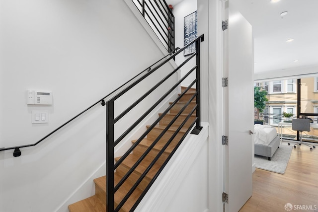 stairs with hardwood / wood-style floors