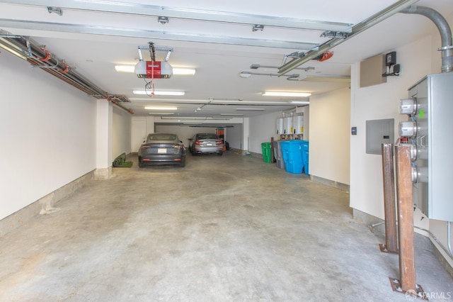 garage with a garage door opener and electric panel