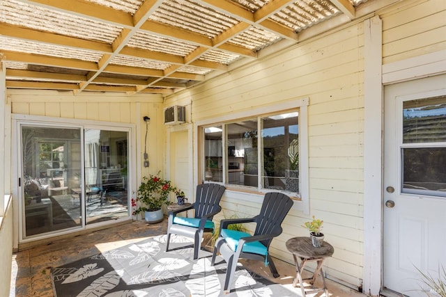 view of patio / terrace featuring a pergola and a wall unit AC