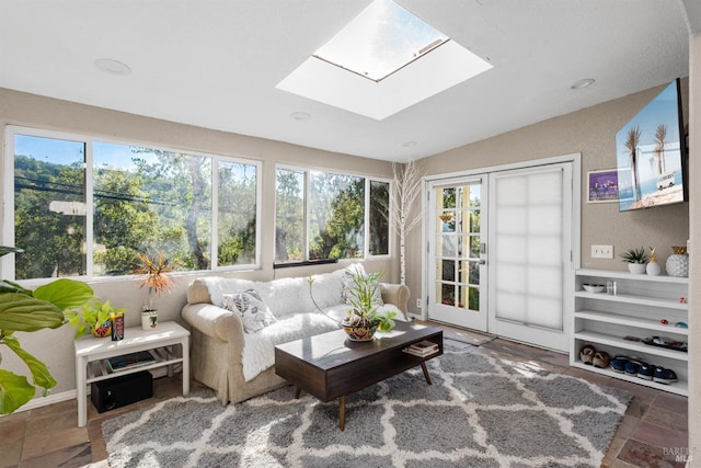 sunroom / solarium with lofted ceiling with skylight