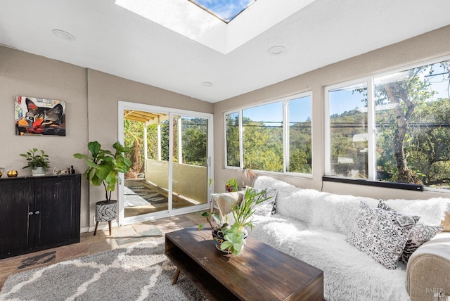 sunroom featuring a healthy amount of sunlight and lofted ceiling with skylight