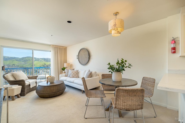 carpeted dining space featuring a mountain view