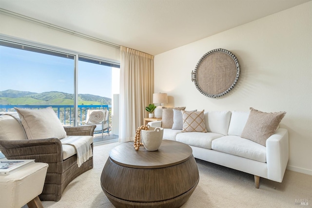 carpeted living room with a mountain view