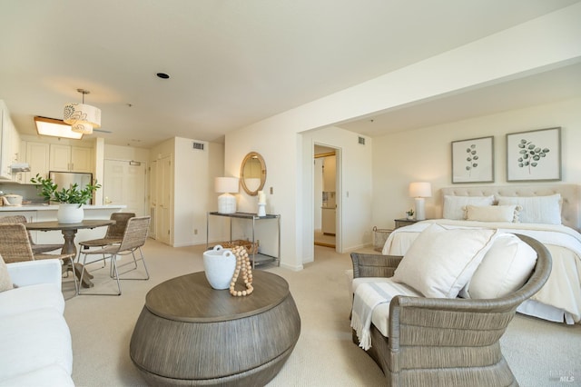 carpeted bedroom featuring stainless steel refrigerator