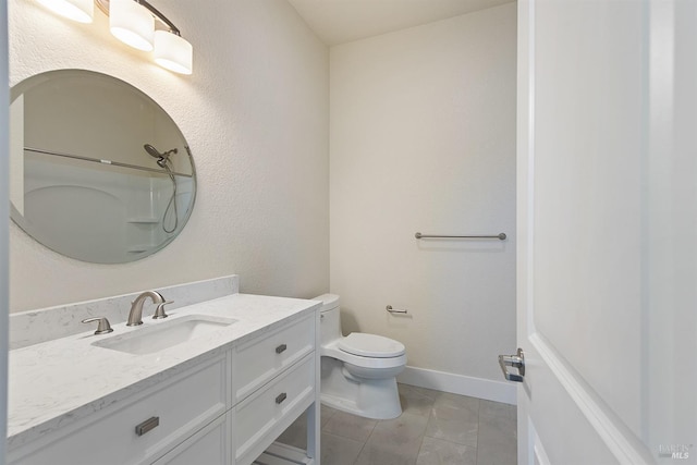 bathroom featuring walk in shower, vanity, tile patterned flooring, and toilet