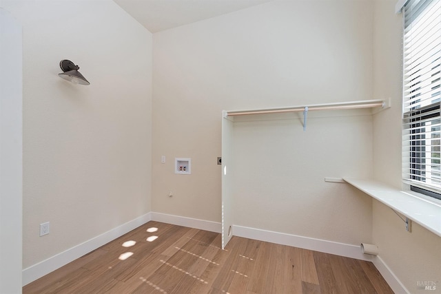 laundry room with washer hookup and light hardwood / wood-style flooring