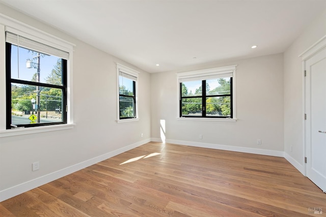 spare room featuring light wood-type flooring