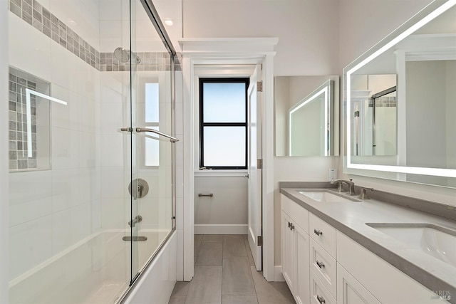 bathroom with tile patterned floors, vanity, and enclosed tub / shower combo