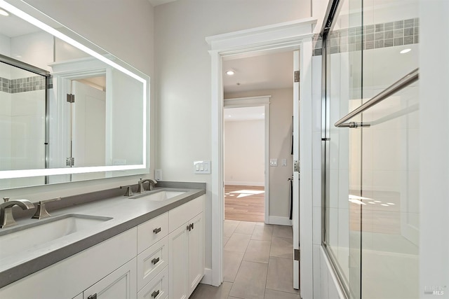 bathroom with walk in shower, tile patterned floors, and vanity