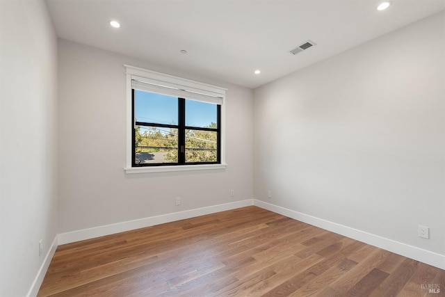 spare room featuring wood-type flooring