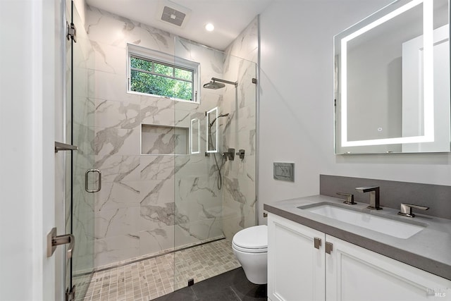 bathroom featuring vanity, a shower with shower door, toilet, and tile patterned flooring