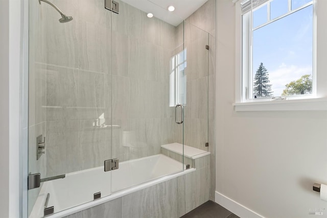 bathroom featuring a healthy amount of sunlight and separate shower and tub