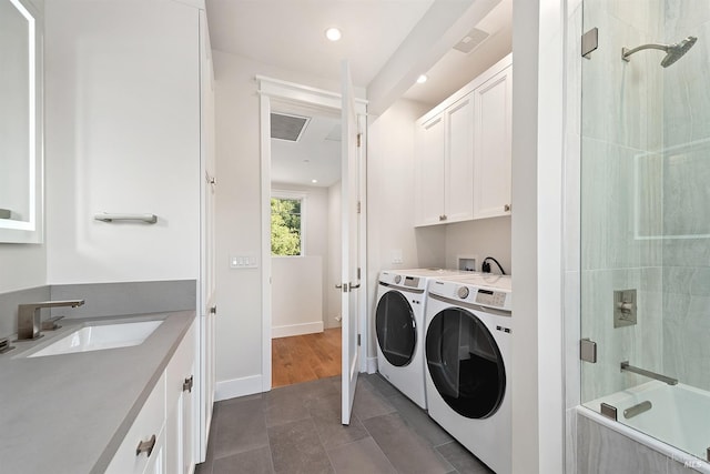 laundry room featuring separate washer and dryer, sink, and dark hardwood / wood-style floors