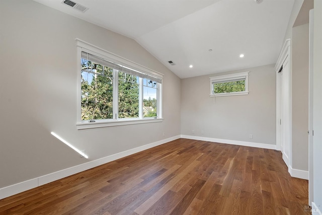 unfurnished bedroom featuring hardwood / wood-style floors and vaulted ceiling