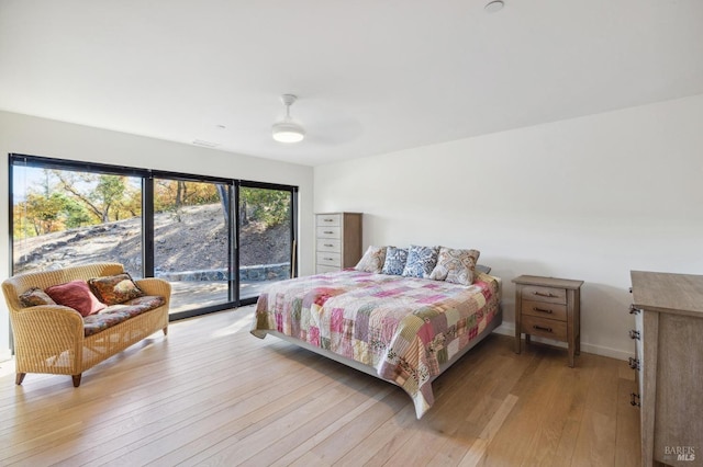 bedroom with access to exterior, light wood-type flooring, and ceiling fan