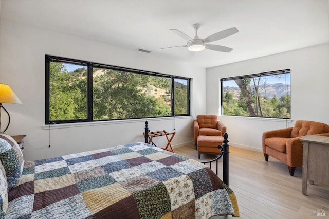 bedroom with ceiling fan and light wood-type flooring