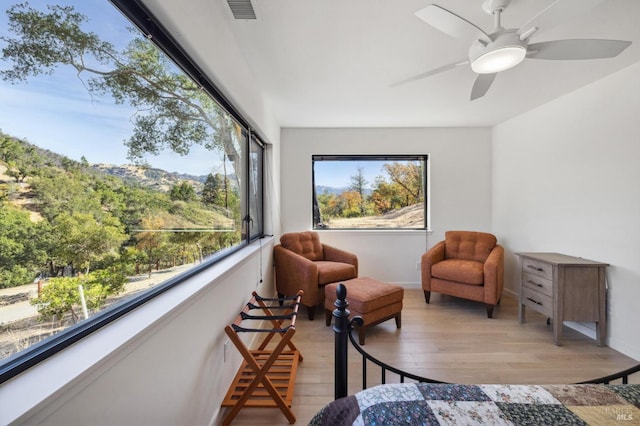 interior space with light hardwood / wood-style flooring and ceiling fan