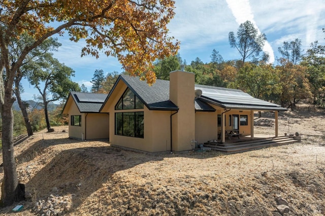 rear view of house with solar panels