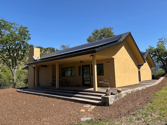 rear view of house with solar panels