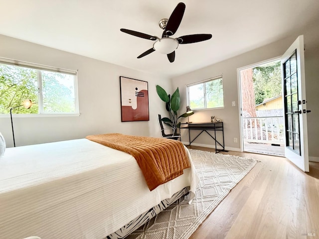 bedroom featuring access to exterior, light wood-type flooring, and ceiling fan