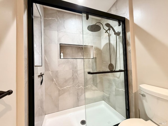 bathroom with an enclosed shower and toilet