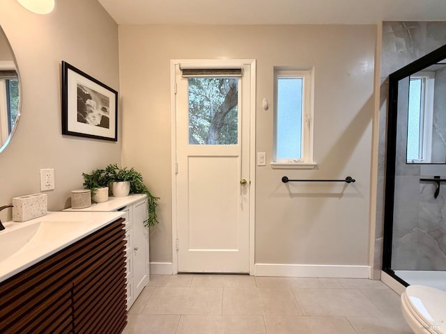 bathroom with vanity, a shower with door, tile patterned flooring, and toilet