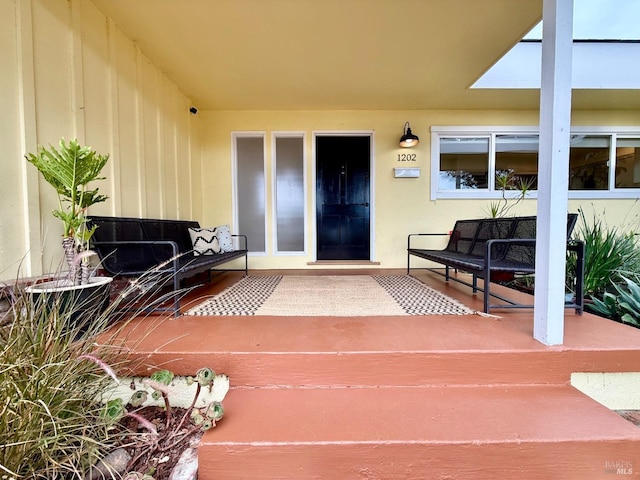 view of exterior entry featuring outdoor lounge area