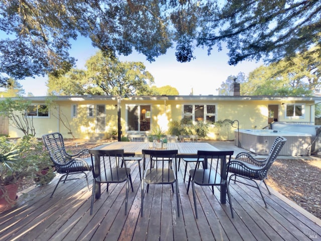 wooden deck featuring a hot tub