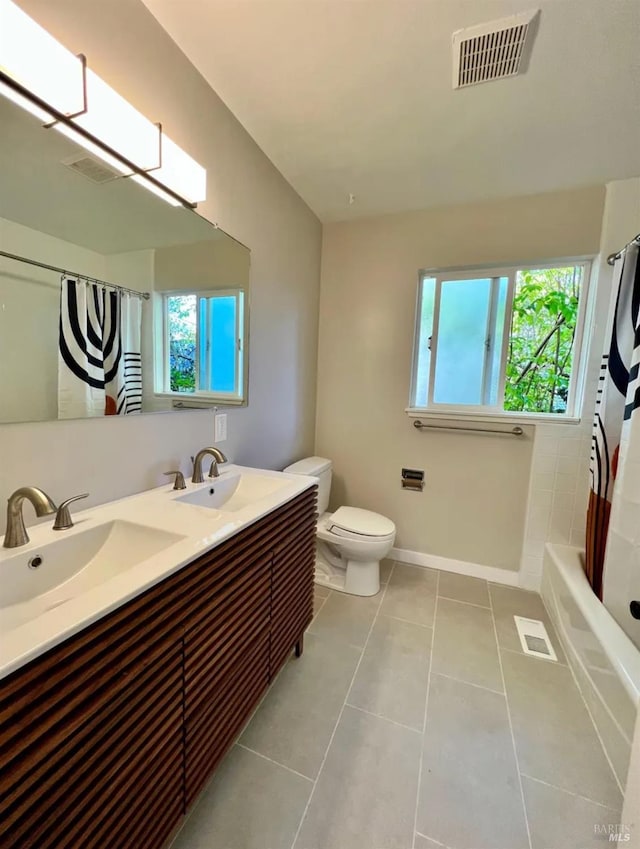 full bathroom with tile patterned flooring, shower / bath combo with shower curtain, vanity, and toilet