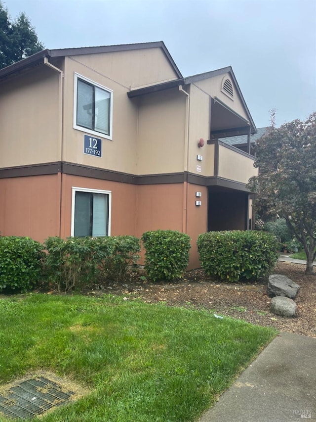 view of property exterior featuring a lawn