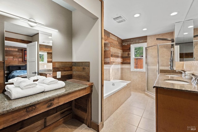 bathroom with tile patterned flooring, vanity, and separate shower and tub