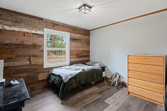 bedroom featuring dark hardwood / wood-style floors and wood walls