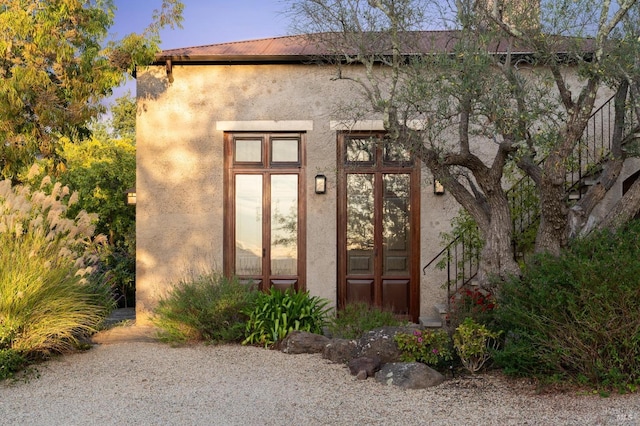 property entrance with stucco siding