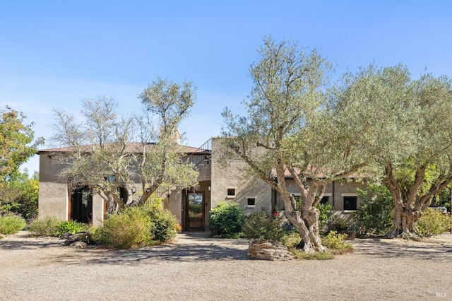 pueblo-style home with stucco siding