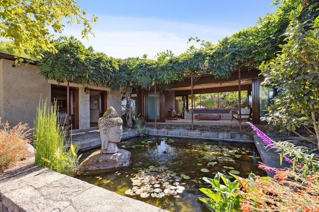 exterior space featuring a garden pond