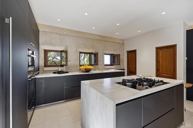 kitchen with modern cabinets, a center island, recessed lighting, appliances with stainless steel finishes, and light countertops