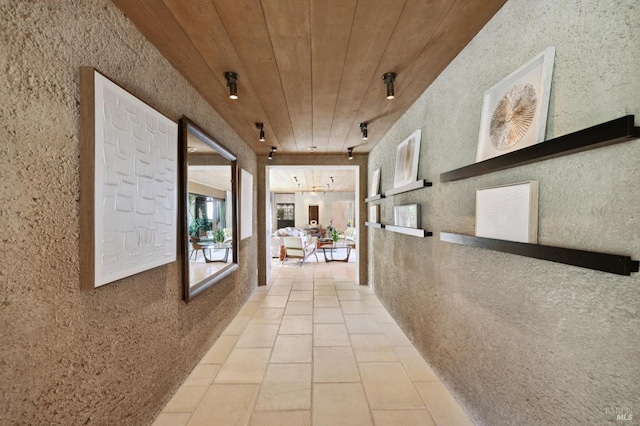 hall featuring tile patterned floors and wood ceiling