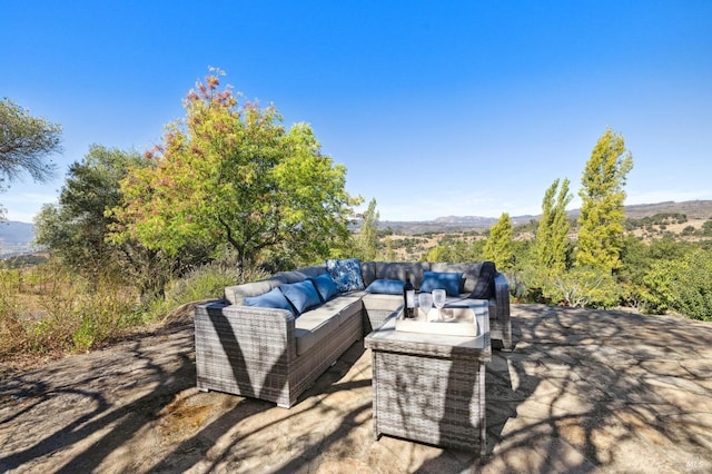 view of patio / terrace featuring a mountain view and an outdoor hangout area