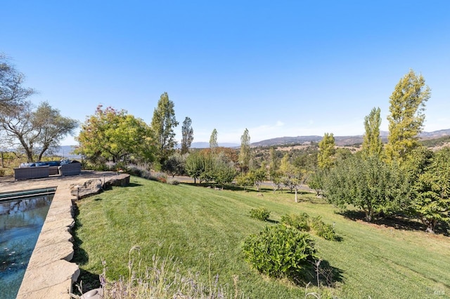 view of yard featuring an outdoor living space and a mountain view