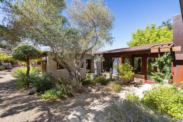 rear view of property with stucco siding