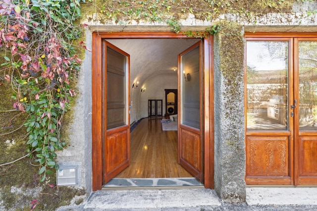 doorway to property featuring visible vents and stucco siding