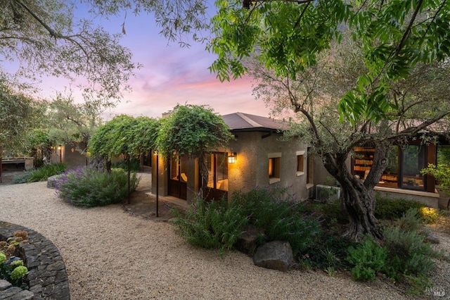 exterior space with stucco siding and a sunroom