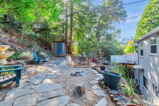 view of patio / terrace with a storage shed and a wooden deck