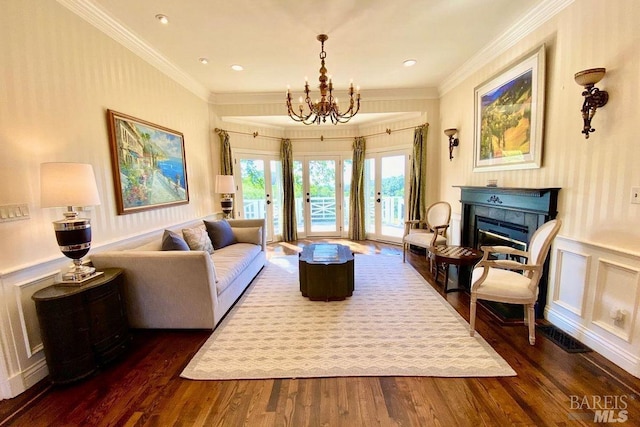 sitting room featuring crown molding, french doors, an inviting chandelier, and dark hardwood / wood-style flooring
