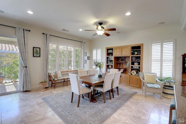 dining space with ornamental molding, light tile patterned floors, and ceiling fan