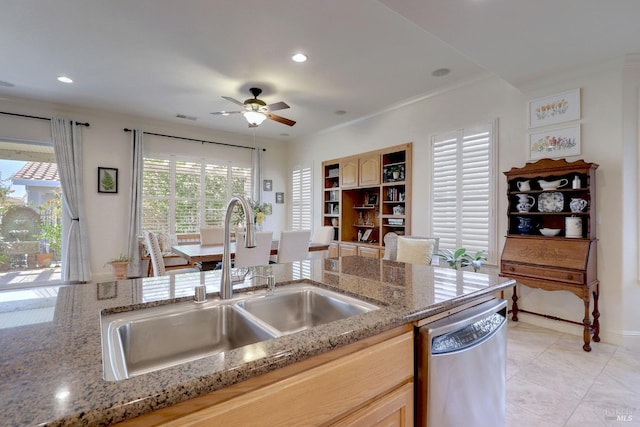 kitchen with light brown cabinets, dishwasher, sink, and ceiling fan